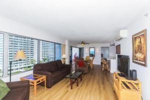 a living room with a couch and a tv at Ilikai Tower 943 in Honolulu