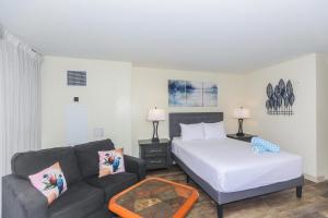 a living room with a bed and a couch at Ilikai Marina 1381 in Honolulu
