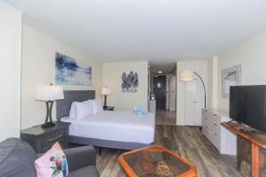 a hotel room with a bed and a tv at Ilikai Marina 1381 in Honolulu