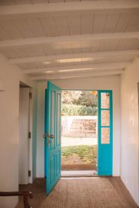 a blue door in a room with a window at Just Like Home - Casa do Botijal in Caminha