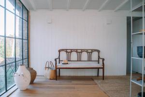 a room with a bench in the corner of a room at Just Like Home - Casa do Botijal in Caminha +56 photos