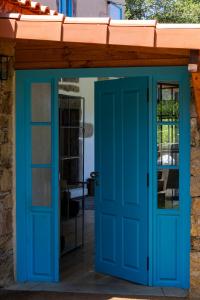 a blue door leading into a house at Just Like Home - Casa do Botijal in Caminha