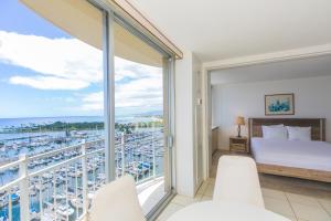a bedroom with a view of a marina at Ilikai Marina 1688 in Honolulu