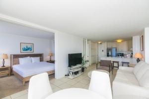 a bedroom with a bed and a living room at Ilikai Marina 1688 in Honolulu