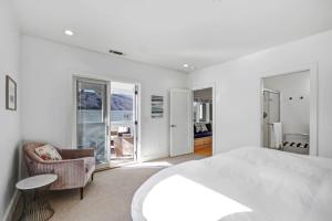 a white bedroom with a bed and a chair at Perfect Friends Getaway in Sonoma in Sonoma