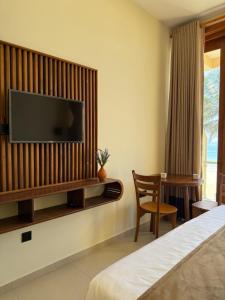 a hotel room with a television on a wall at Piña Boutique Hotel - Beachfront in Habaraduwa Central