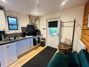 a kitchen with a blue couch in a room at The Canal Cabin in Banavie