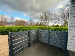 a wooden fence on the side of a house at The Canal Cabin in Banavie