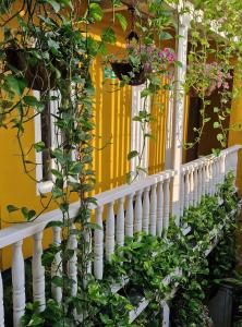a white balcony with plants and flowers on it at Maloka Boutique Centro Histórico in Cartagena de Indias