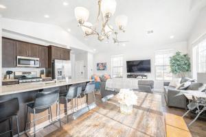 a kitchen and living room with a table and chairs at Adventures Base! Family Friendly w heated community pool in Washington
