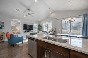 a kitchen with a sink and a living room at Adventures Base! Family Friendly w heated community pool in Washington