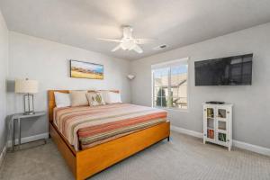 a bedroom with a bed and a flat screen tv at Adventures Base! Family Friendly w heated community pool in Washington +22 photos