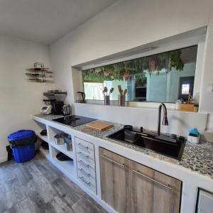 a kitchen with a sink and a counter top at Casa Rural Mayné in Villafranca de los Caballeros