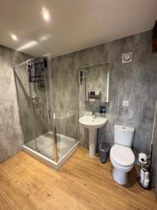 a bathroom with a shower and a toilet and a sink at The Granary, Wolds Way Holiday Cottages, spacious 3 bed cottage in Cottingham +19 photos