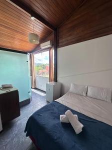 a bedroom with a bed with a towel on it at Vista Beach Ingleses in Florianópolis +26 photos