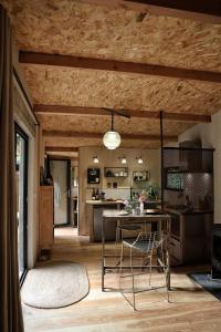 a kitchen with a table and a dining room at Lodge La Clède in Concoules