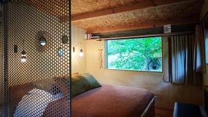 a bedroom with a window and a bed in a room at Lodge La Clède in Concoules