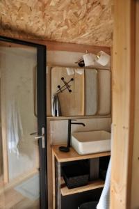 a small bathroom with a sink in a tiny house at Lodge La Clède in Concoules +23 photos