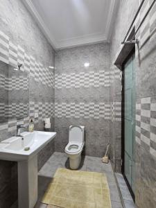a bathroom with a white sink and a toilet at Gifted Estates in Accra +25 photos
