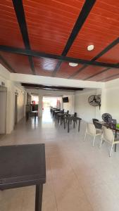 a group of tables and chairs in a room at Casa Hotel Estelar in Villavieja