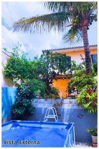 a palm tree and a swimming pool in front of a building at Alure 1 in Belo Horizonte