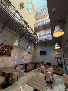 a restaurant with tables and chairs in a room at The Originals Boutique, Le Grand Hôtel Molière, Pézenas in Pézenas
