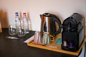 a tea kettle and cups on a wooden tray at Relais Manderen in Manderen