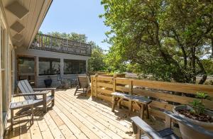 a wooden deck with chairs and tables and a balcony at Casa La Playa - Duck, Sanderling, Lakefront, 160 Yards to the Beach, Community Pool, Pets OK in Duck