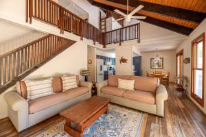 a living room with two couches and a table at Casa La Playa - Duck, Sanderling, Lakefront, 160 Yards to the Beach, Community Pool, Pets OK in Duck