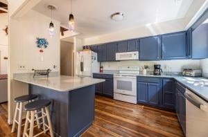 a kitchen with blue cabinets and a counter top at Casa La Playa - Duck, Sanderling, Lakefront, 160 Yards to the Beach, Community Pool, Pets OK in Duck +44 photos