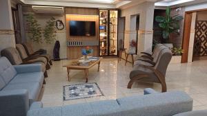 a lobby with couches and a table and a tv at HOTEL MARIANI in Lajeado