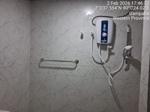 a bathroom with a shower with a phone on the wall at Slayan-1 properties in Mudungoda