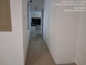 a hallway with a white wall and a white floor at Slayan-1 properties in Mudungoda