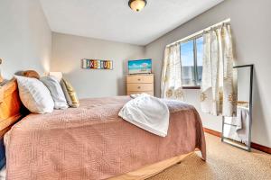 a bedroom with a large bed and a window at Bridges Bay Vacation Cabin 33 in Arnolds Park +30 photos