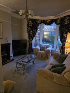 a living room with a couch and a table at The Ormerod in Burnley
