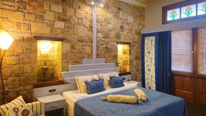a bedroom with a bed and a stone wall at Eski Masal Hotel - Special Class in Antalya +168 photos