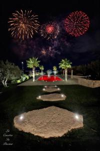 a firework display in a park with palm trees at La Casetta In Piscina in Matera +79 photos