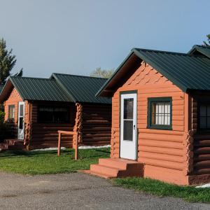 a small log cabin with a white door at Blue Moon Saloon in Cameron