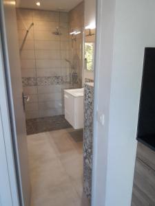 a bathroom with a shower and a sink and a tub at Le repos des crêtes in Cavalaire-sur-Mer +73 photos