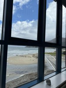 a view of the beach from a window at John's Luxury Seafront Apartment in Newcastle