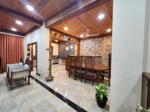 a dining room with a table and chairs at Mahizh Manai in Jaffna