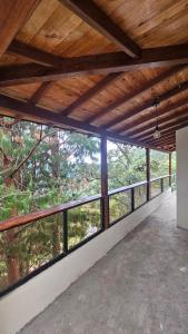 an empty room with a view of a forest at Aitana Mágica in Copacabana