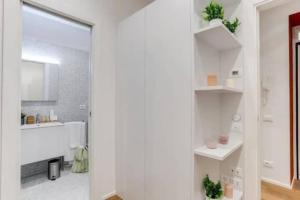a white bathroom with a tub and a sink at Vaticano luxury sleep in Rome +53 photos