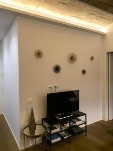 a living room with a flat screen tv on a wall at Vaticano luxury sleep in Rome
