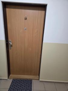 a wooden door with the number on it at Apartmán KN in Liptovský Mikuláš +1 photo