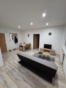 a living room with a couch and a table at Apartmán KN in Liptovský Mikuláš