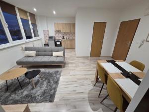 a living room with a couch and a table at Apartmán KN in Liptovský Mikuláš