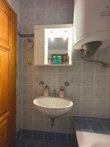 a bathroom with a sink and a mirror at Kofinas villa Evdilos by BRP-PROPERTIES in Evdilos