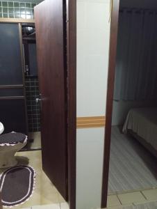 a door in a room with a bedroom at Casa Quarto 1 in Jaraguá do Sul