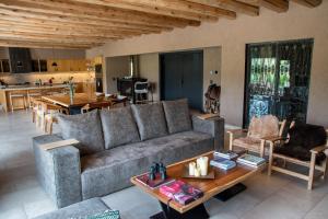 a living room with a couch and a table at Rancho Adobe Eco Hotel in Tupungato